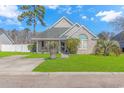 House exterior showcasing landscaping, driveway, and architectural details at 204 Atoll Dr., Myrtle Beach, SC 29588