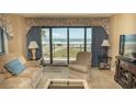 Living room with ocean view and comfy seating at 2200 N Ocean Blvd., North Myrtle Beach, SC 29582