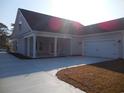 Single-Gathering home with a covered patio and an attached two-car garage and concrete driveway at 2220 Pettus Way, Surfside Beach, SC 29575