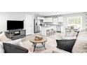 Open-concept living room with modern furnishings, connecting to a bright kitchen and dining area at 290 Myrtle Meadows Dr # 505F, Conway, SC 29526