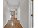 Inviting hallway with hardwood floors, neutral paint, and multiple doorways leading to other rooms at 4672 Lightkeepers Way # 50-E, Little River, SC 29566
