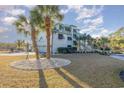 Three-story home with white exterior and palm trees at 47 Isle Of Palms Dr., Murrells Inlet, SC 29576