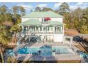 Large swimming pool with patio furniture and outdoor kitchen at 47 Isle Of Palms Dr., Murrells Inlet, SC 29576
