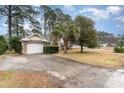 House exterior showcasing a driveway, landscaping and garage at 4712 Southern Trail, Myrtle Beach, SC 29579