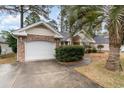Attached garage with a white door and brick facade at 4712 Southern Trail, Myrtle Beach, SC 29579