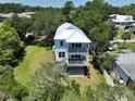 Beautiful home with a metal roof and dual decks surrounded by lush greenery and a spacious yard at 48 Furman Ln., Pawleys Island, SC 29585