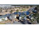 Aerial view showing condo building near a golf course and pond at 517 White River Ct. # 22A, Myrtle Beach, SC 29579