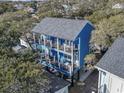 Elevated view of a two-story blue house with a spacious deck at 6001 South Kings Hwy., Myrtle Beach, SC 29575