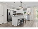 Modern kitchen with white cabinets, granite island, and stainless steel appliances at 608 Montenegro Way # D, Myrtle Beach, SC 29579