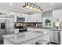 Modern kitchen with white cabinets, granite countertops, and stainless steel appliances at 608 Montenegro Way # D, Myrtle Beach, SC 29579