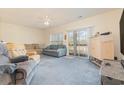 Living room features carpet, two sofas, and sliding glass doors to balcony at 1058 Sea Mountain Hwy. # 1-303, North Myrtle Beach, SC 29582