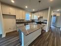 Modern kitchen featuring a large island, stainless steel appliances, and granite countertops at 1257 Lady Bird Way, North Myrtle Beach, SC 29582