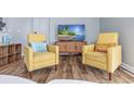 Living room with two yellow armchairs and a TV at 1356 Glenns Bay Rd. # 208M, Surfside Beach, SC 29575