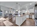Open-concept kitchen with island, stainless appliances, and seamless flow to the living area at 1405 Osprey Pointe Ln., North Myrtle Beach, SC 29582