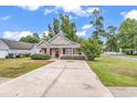 Inviting single-story home with a well-maintained lawn and spacious driveway at 1900 Shell Ct., Surfside Beach, SC 29575