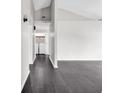 Bright hallway with sleek, dark hardwood floors, and a laundry area visible in the background at 1900 Shell Ct., Surfside Beach, SC 29575