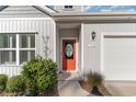 Charming house exterior with orange front door and attached garage at 192 Sea Shell Dr. # 22, Murrells Inlet, SC 29576