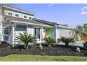 Gray house with a large tree in front and manicured lawn at 21 Pine Valley Ln., Surfside Beach, SC 29575