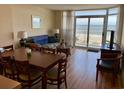 Living room with ocean view, dining table, and seating at 2504 Ocean Blvd. N # 232, Myrtle Beach, SC 29577