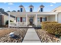 Inviting front porch with a white railing and landscaping at 29 Saltwind Loop, Murrells Inlet, SC 29576