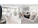 Open concept living room and kitchen with hardwood floors at 3180 Nw Edgemead Circle # B, Calabash, NC 28467