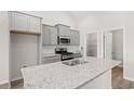 Modern kitchen with stainless appliances, center island with granite countertops, and pantry at 391 Lifestyle Court, Surfside Beach, SC 29575