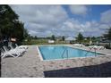 Relaxing community pool with clear blue water, surrounded by lounge chairs and well-maintained landscaping at 395 Lifestyle Court, Surfside Beach, SC 29575