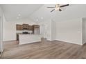 Open-concept living space featuring wood-look floors, vaulted ceilings, and modern ceiling fan at 399 Lifestyle Court, Surfside Beach, SC 29575