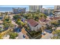 Beachfront property showcasing a luxurious three-story building and ocean views at 400 Hillside Dr. N # 302C, North Myrtle Beach, SC 29582