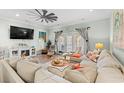 Spacious living area with comfortable seating, large TV, and access to a balcony at 400 Hillside Dr. N # 302C, North Myrtle Beach, SC 29582