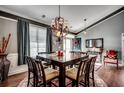 Open dining room with a view to the foyer, complete with decorative lighting and seating for six guests at 4382 Saint Annes Ct., Myrtle Beach, SC 29579