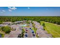 Aerial view of the neighborhood featuring a community pool, plenty of parking, and bordering a golf course at 4657 Fringetree Dr. # C, Murrells Inlet, SC 29576