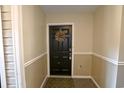 Inviting entryway featuring a welcoming black front door with wreath and a patterned welcome mat at 4657 Fringetree Dr. # C, Murrells Inlet, SC 29576