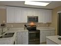 Modern kitchen featuring white cabinets, stainless steel appliances, and bright marble countertops at 4657 Fringetree Dr. # C, Murrells Inlet, SC 29576