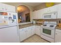 Well-equipped kitchen featuring white cabinets, granite countertops, and modern appliances at 5801 Oyster Catcher Dr. # 1624, North Myrtle Beach, SC 29582