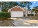 Brick house with a two-car garage and landscaped front yard at 638 Needlerush Ct., Myrtle Beach, SC 29579