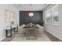 Modern dining room featuring a glass-top table, six chairs, and a statement wall at 878 Snowberry Dr., Longs, SC 29568