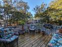 Deck with wicker chairs, potted plants, and a grill at 88 Salt Marsh Circle # 22H, Pawleys Island, SC 29585