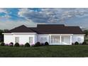 Back of house with white exterior, black roof, and covered patio at Tbd Pettus Way, Surfside Beach, SC 29575