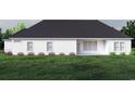 White farmhouse rear view with covered patio and landscaping at 2180 Pettus Way, Surfside Beach, SC 29575