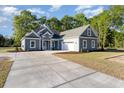 Beautiful home with a well-kept lawn, concrete driveway, and an attached garage, perfect for suburban living at 1033 Pisgah Church Rd., Aynor, SC 29511