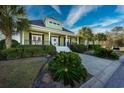 House exterior showcasing a front porch and lush landscaping at 1204 Wading Heron Rd., North Myrtle Beach, SC 29582
