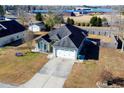 An aerial view showcasing a house with a two-car garage and a spacious yard at 130 Lions Paw Ct., Loris, SC 29569