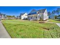 Houses with front porches and green lawns at 150 Black Water Dr., Murrells Inlet, SC 29576