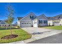 Two-car garage with driveway and landscaping at 150 Black Water Dr., Murrells Inlet, SC 29576