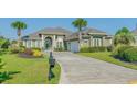 Beautiful home featuring a well-manicured lawn, lush landscaping, and a spacious driveway at 2000 Hideaway Point, Myrtle Beach, SC 29579