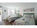 Two twin beds with beach decor in a well-lit room at 210 75Th Ave N # 4011, Myrtle Beach, SC 29572