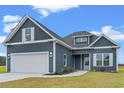Newly built home with gray siding, white garage door, and landscaping at 216 William Nobles Rd., Aynor, SC 29511