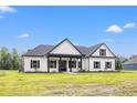 New construction white farmhouse with black accents and a large yard at 224 William Nobles Rd., Aynor, SC 29511
