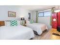 Guest bedroom with two twin beds, nightstands, and a red dresser at 2310 North Ocean Blvd. # 605, Myrtle Beach, SC 29577